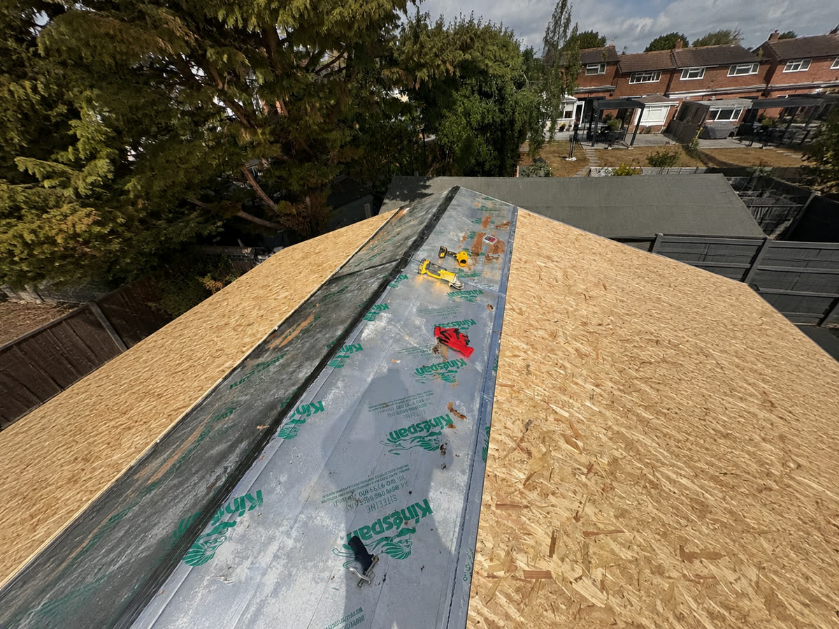 Insulation boards fitted between roof rafters during roof works