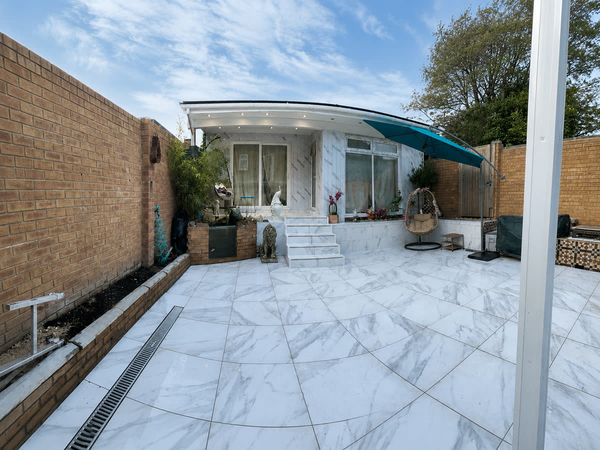 Finished marble patio alongside a completed extension