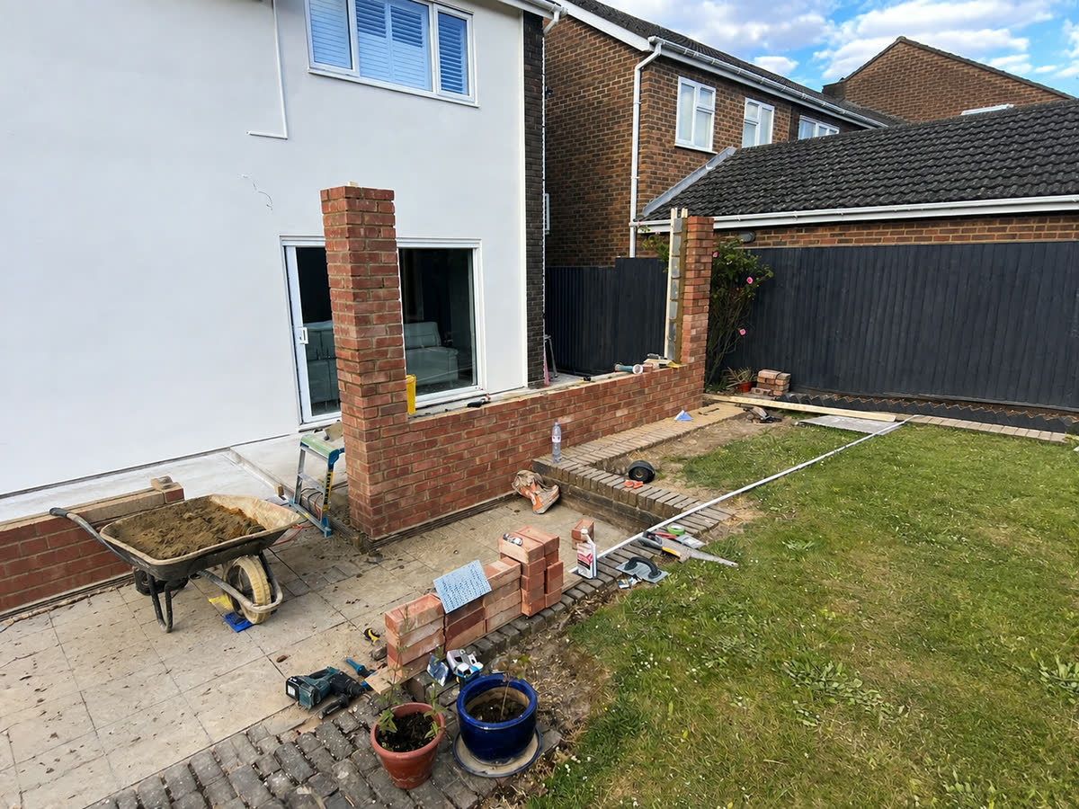 New brickwork alongside a laid patio in a rear garden